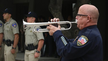 School Board Candidate Tracy Landrus plays taps at Kings County law enforcement event.
